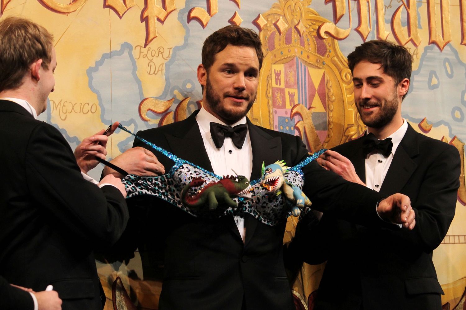 Two members of the Hasty Pudding Theatricals' presents Chris Pratt, Man of the Year, with a dinosaur bra at his roast on Friday evening in Farkas Hall. 