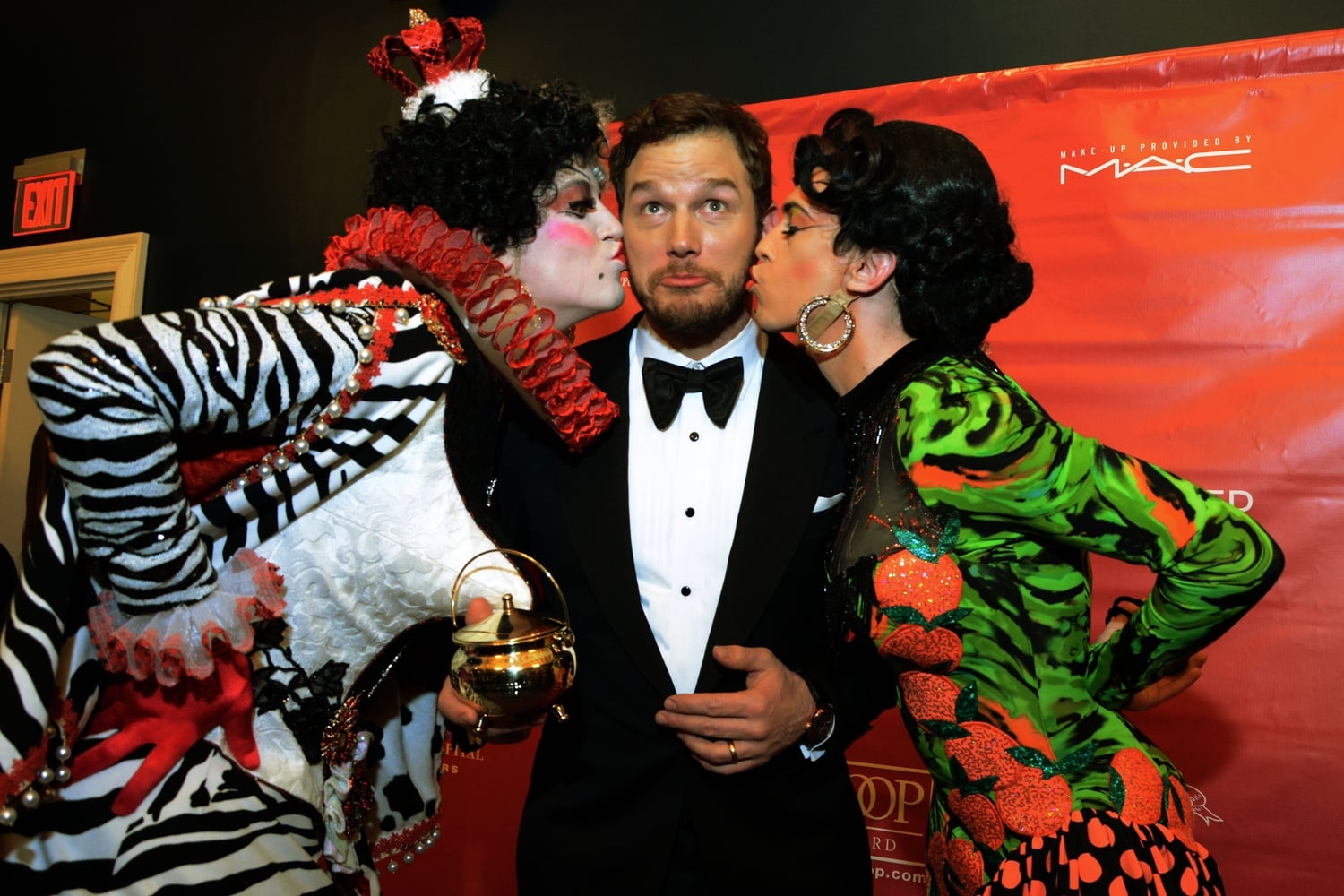 Two members of the Hasty Pudding Theatricals kiss Chris Pratt, Hasty Pudding Theatricals' Man of the Year, as he is presented the Hasty Pudding Pot on Friday evening in Farkas Hall. 