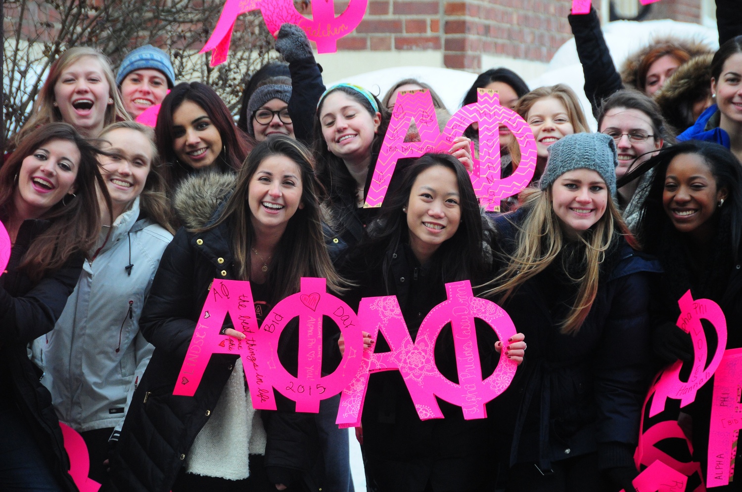 Members of sorority Alpha Phi await outside the Sheraton Commander Hotel to welcome the new members after getting their bids. 