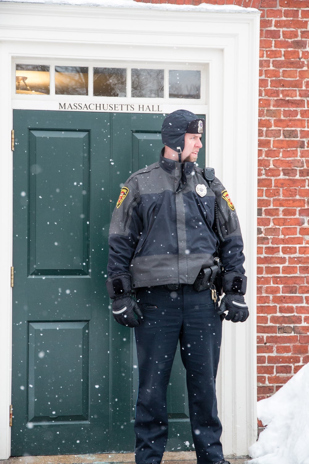 A HUPD officer stands guard outside the entrance to Massachusetts Hall, which members of Divest  Harvard occupy as they call for the divestment of the University's endowment from fossil fuels.