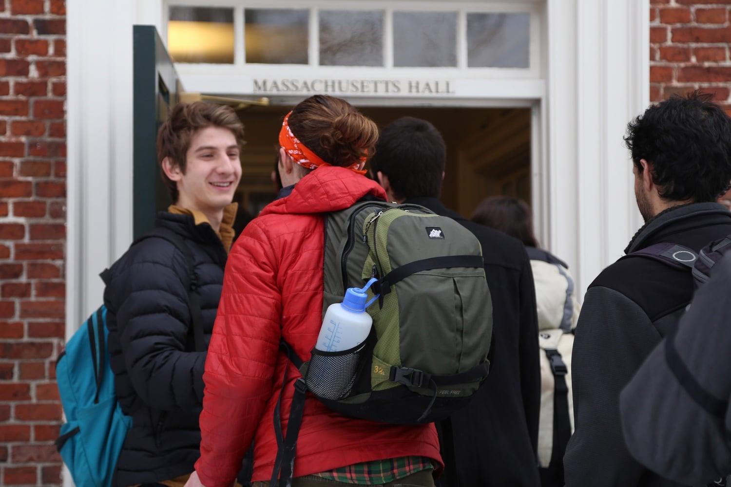 Benjamin D. Sorscher '18 ushers in Henney H. Sullivan '15 into Massachusetts Hall as student group Divest Harvard stages a protest calling for the divestment of fossil fuels on Feb. 12.