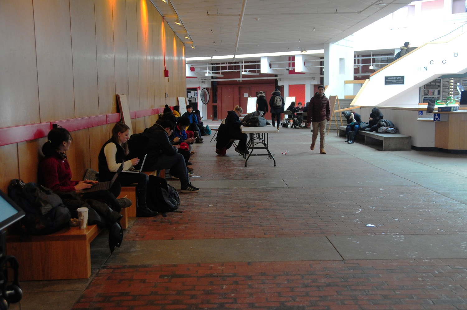 A medley of college students, graduate students, and high school debate students sit out the blizzard on the benches of the Science Center.  Thousands of high school debaters arrived on Harvard's campus over the weekend to participate in the Harvard National Forensics Tournament.  
