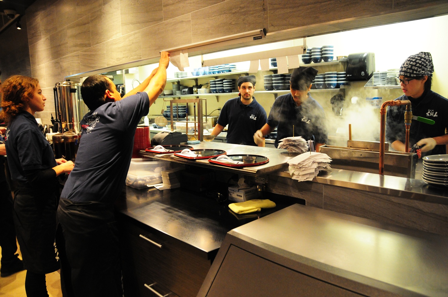 Chefs prepare fresh ramen for waiting customers. Santouka opened its first Massachusetts restaurant in Harvard Square last week.
