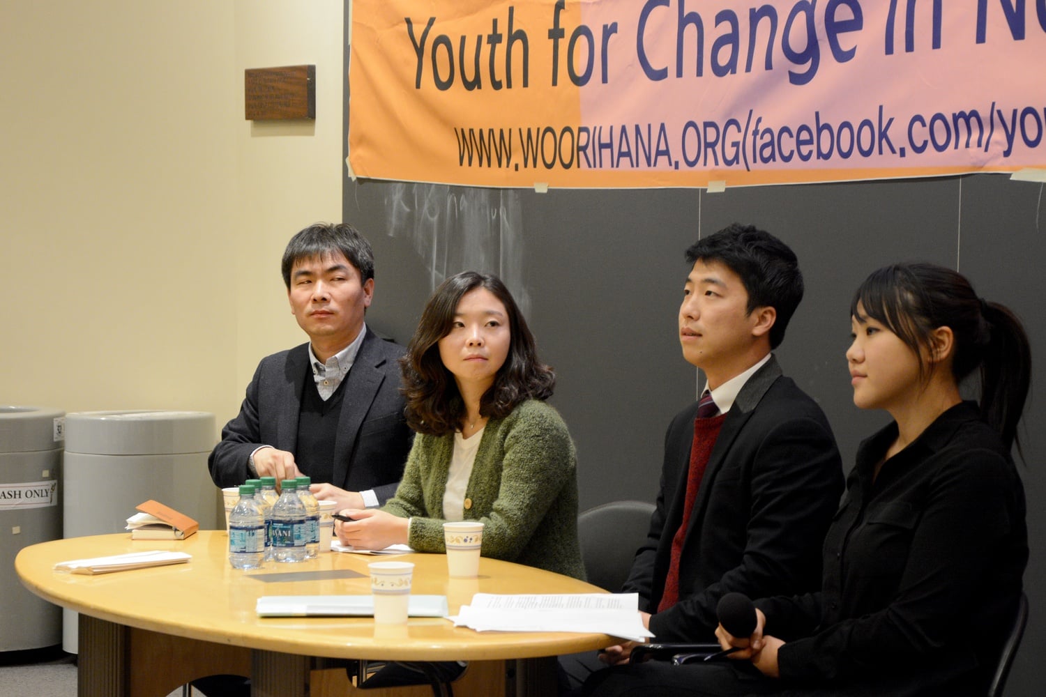Se Jun Park, left, Eunju Kim and Gwang Seong Jung, center, sit on a panel in Fong Auditorium with translator Kitty Chi, right. The three North Korean defectors spoke to students at an event hosted by Harvard HRiNK and WOORIHANA Tuesday evening.
