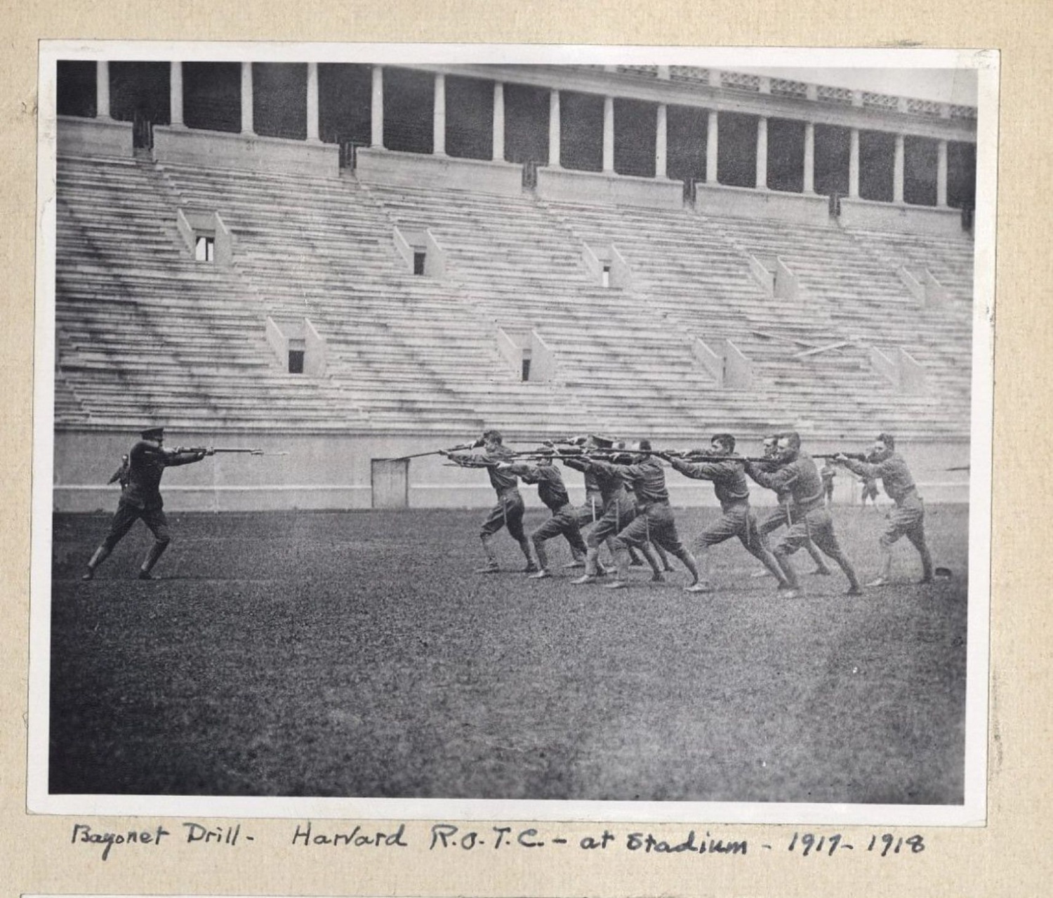 Students practice a bayonet drill at Harvard Stadium in 1917 or 1918 according to an annotation on the photograph.