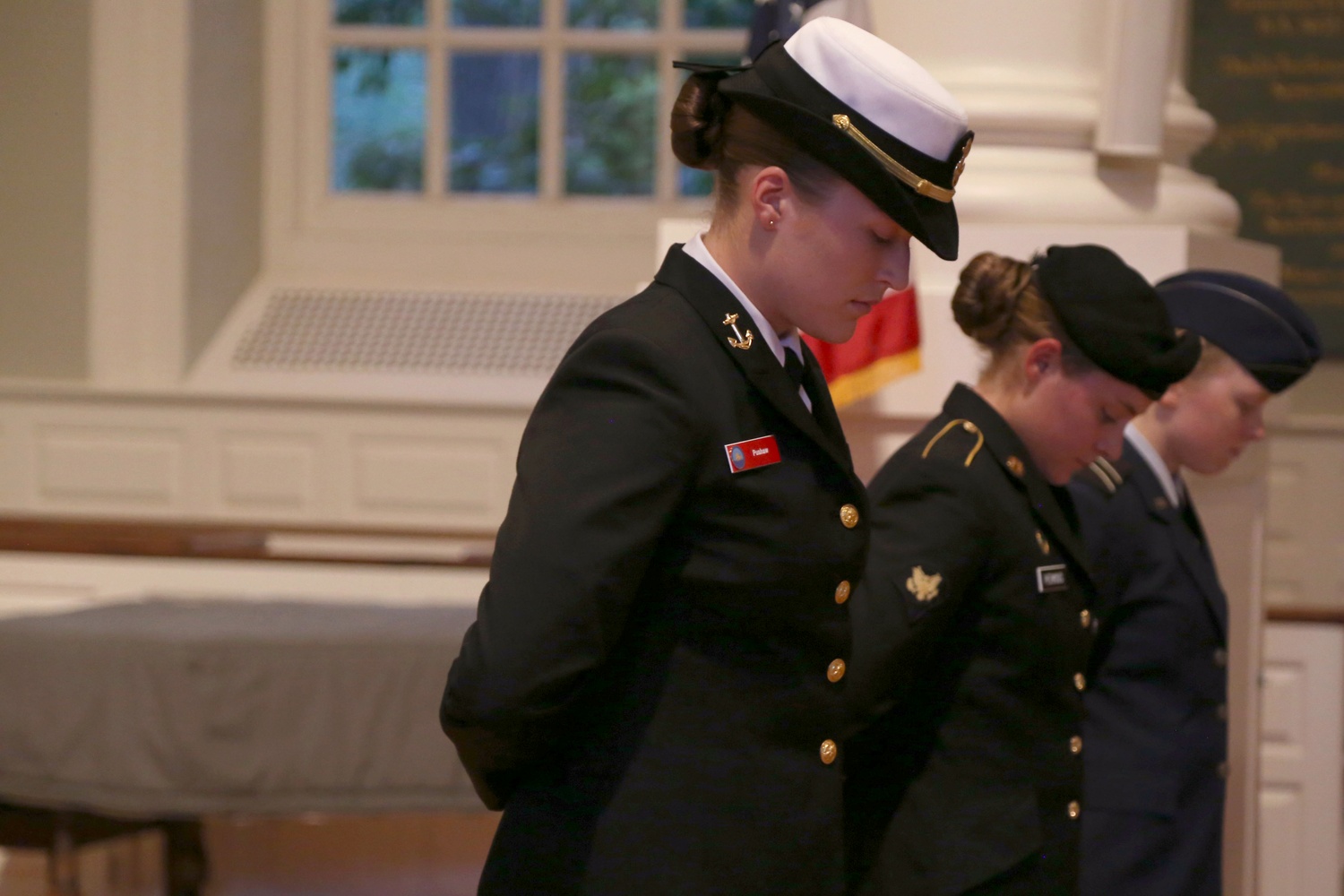 From left, Carolyn F. Pushaw ’16, Lucy F. Perkins, and Kira R. Headrick ’17 bow their heads during a 9/11 memorial service in 2014.