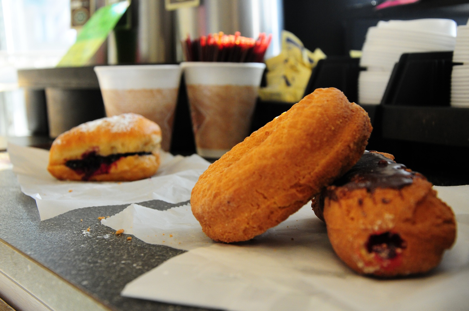 A plain donut and jelly stick from Linda's Donuts in Belmont are compared with a blueberry donut from Ohlin's Bakery, also in Belmont.
