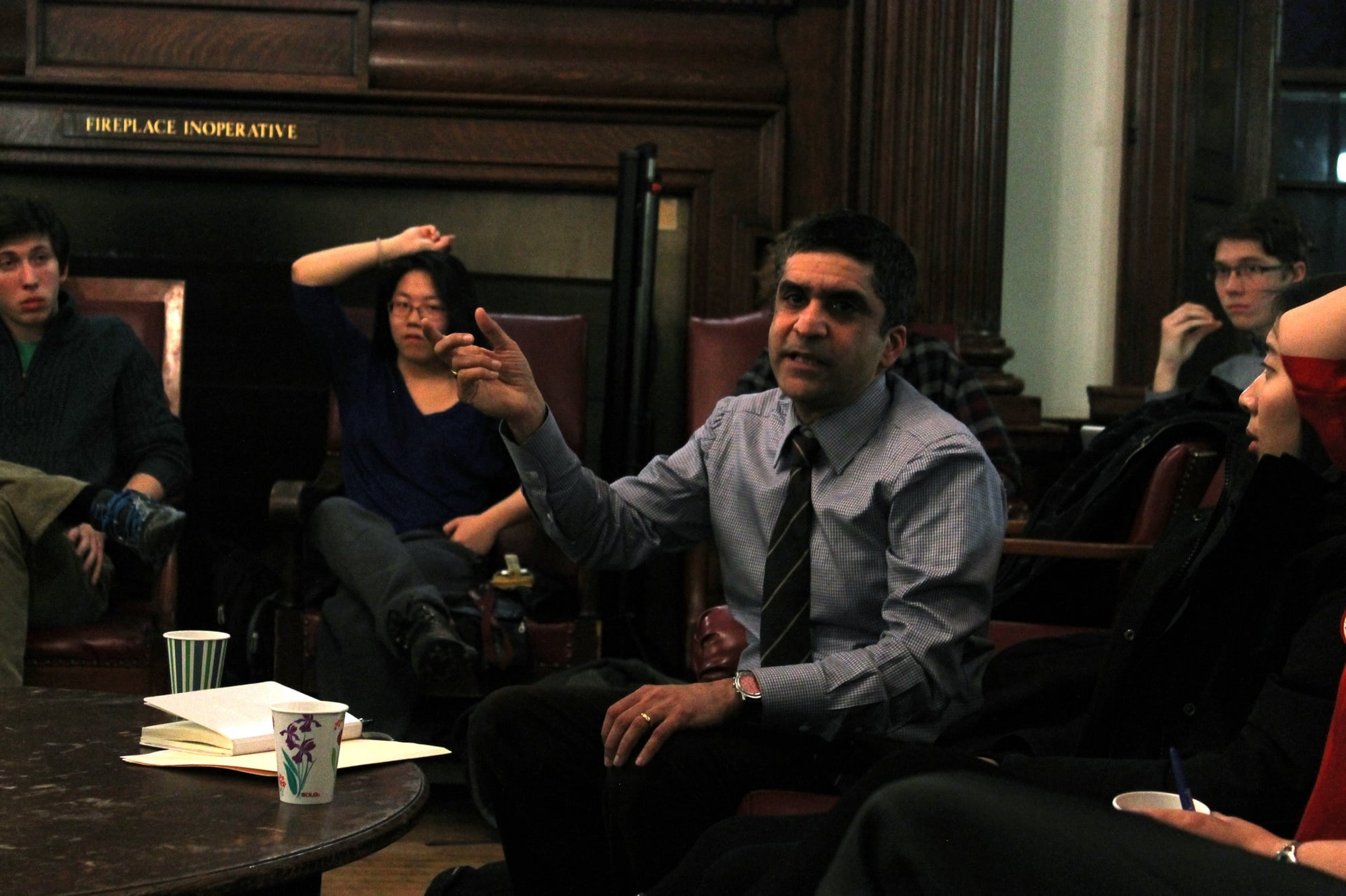 Dean of the College Rakesh Khurana leads a discussion with students about balancing academics and extracurriculars at a town hall in the Phillips Brooks House Parlor on Wednesday evening.