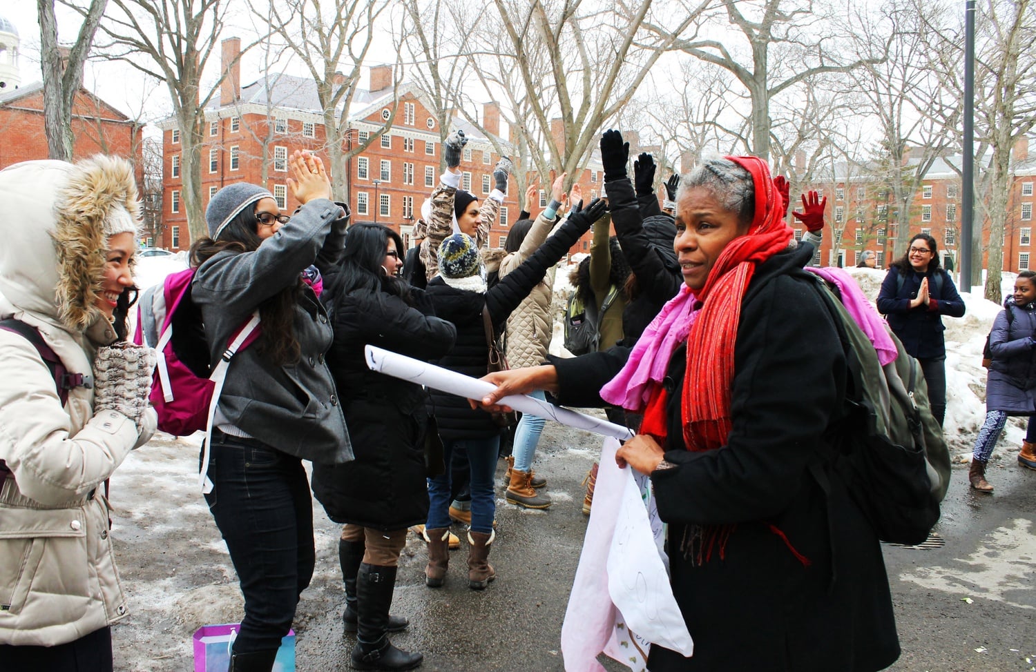 Josefina Báez, a performance artist, instructs students of Spanish 126: “Performing Latinidad” in a spontaneous expressive performance in front of the John Harvard statue in March.