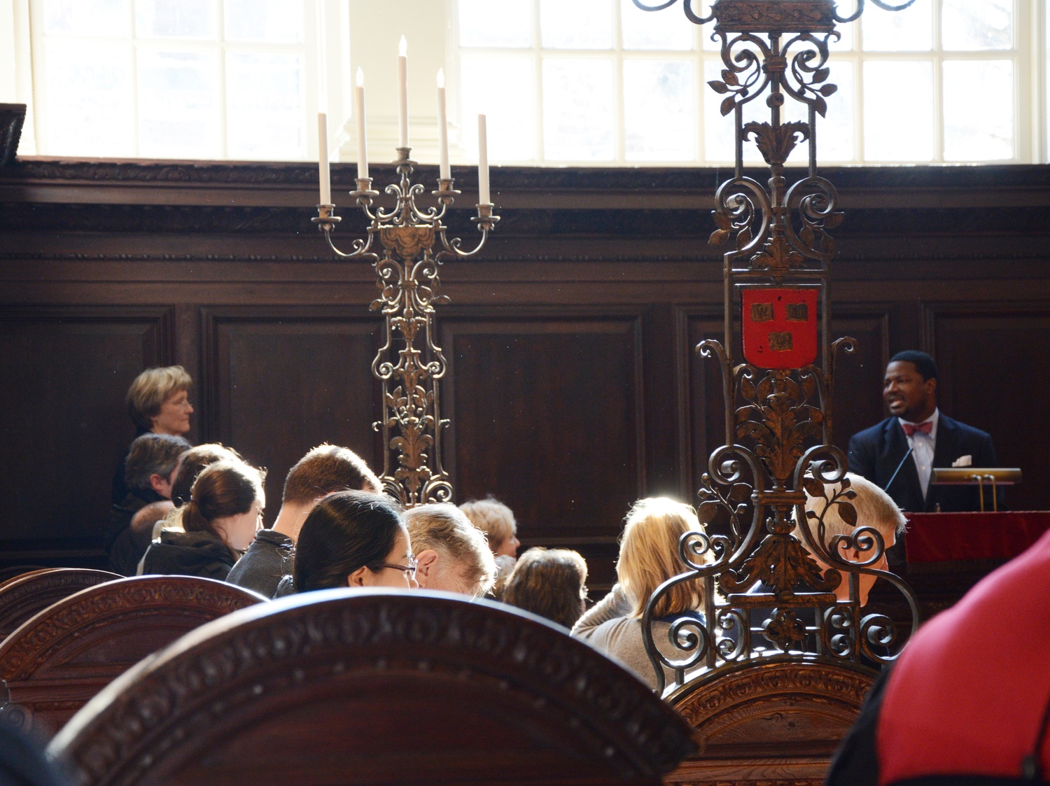 President Drew G. Faust looks on as Pusey Minister in Memorial Church Jonathan L. Walton speaks. On Friday morning, Faust gave a speech during the morning prayers service reflecting on the time when she skipped her midterms as a college freshman to attend the voting rights march at Selma.