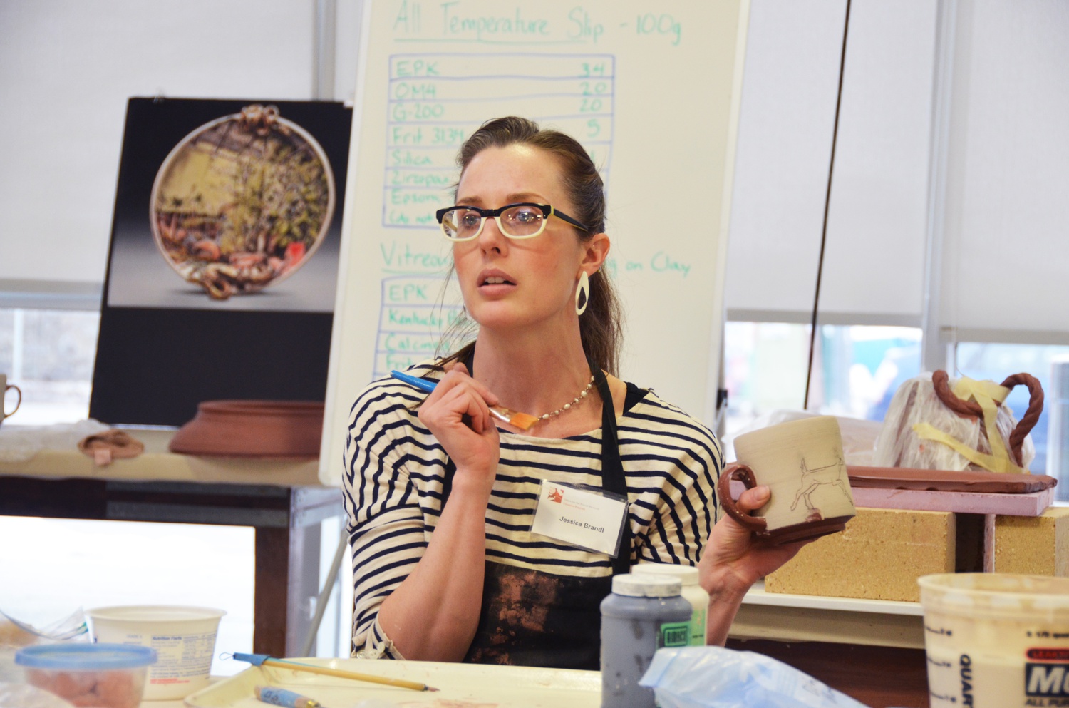Visiting artist Jessica Brandl demonstrates her painting technique during her workshop at the Harvard Ceramics Studio in Allston last Thursday. Brandl uses drawing, painting, and ceramics to create art laden with powerful visual imagery.