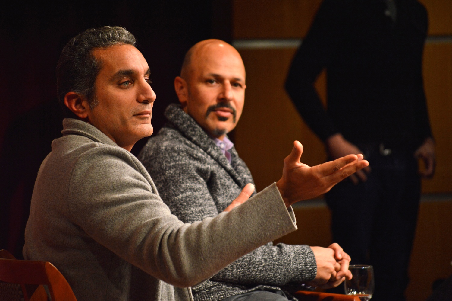 Bassem R. Youssef, a comedian dubbed Egypt’s Jon Stewart gestures towards the audience in one of his responses to Maz Jobrani, sitting behind. Also a comedian, Jobrani exchanged jokes and commentary with Youssef ranging from Jobrani's acting career to the cultural influence of media. 
