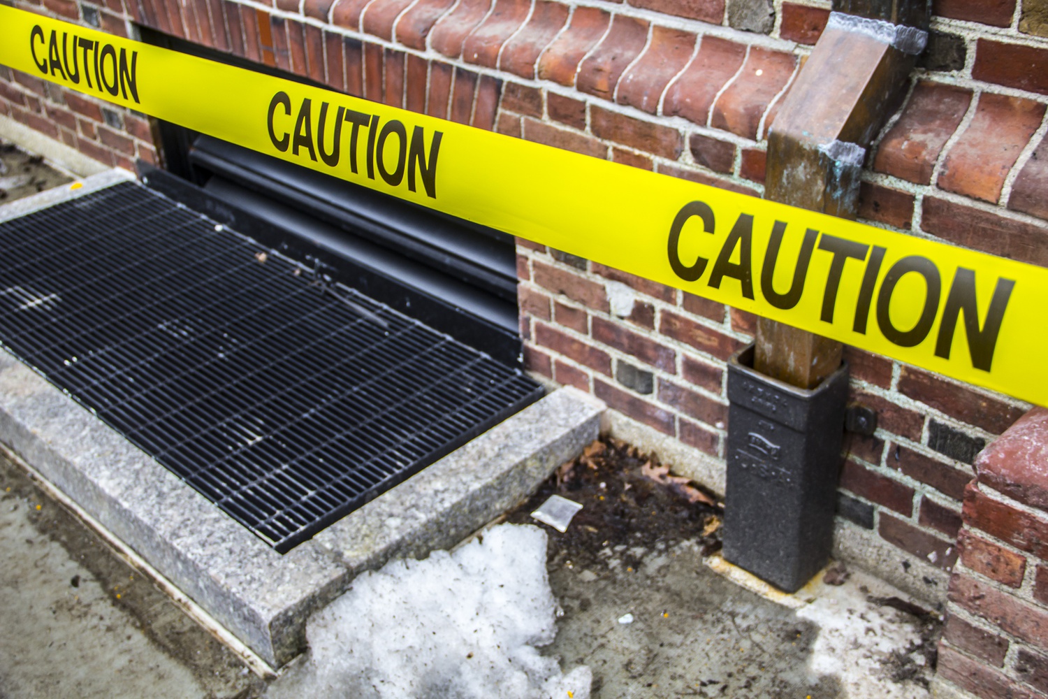 An area is taped off in front of Leverett House due to safety concern about falling icicles. The university is working to clear ice from buildings. 
