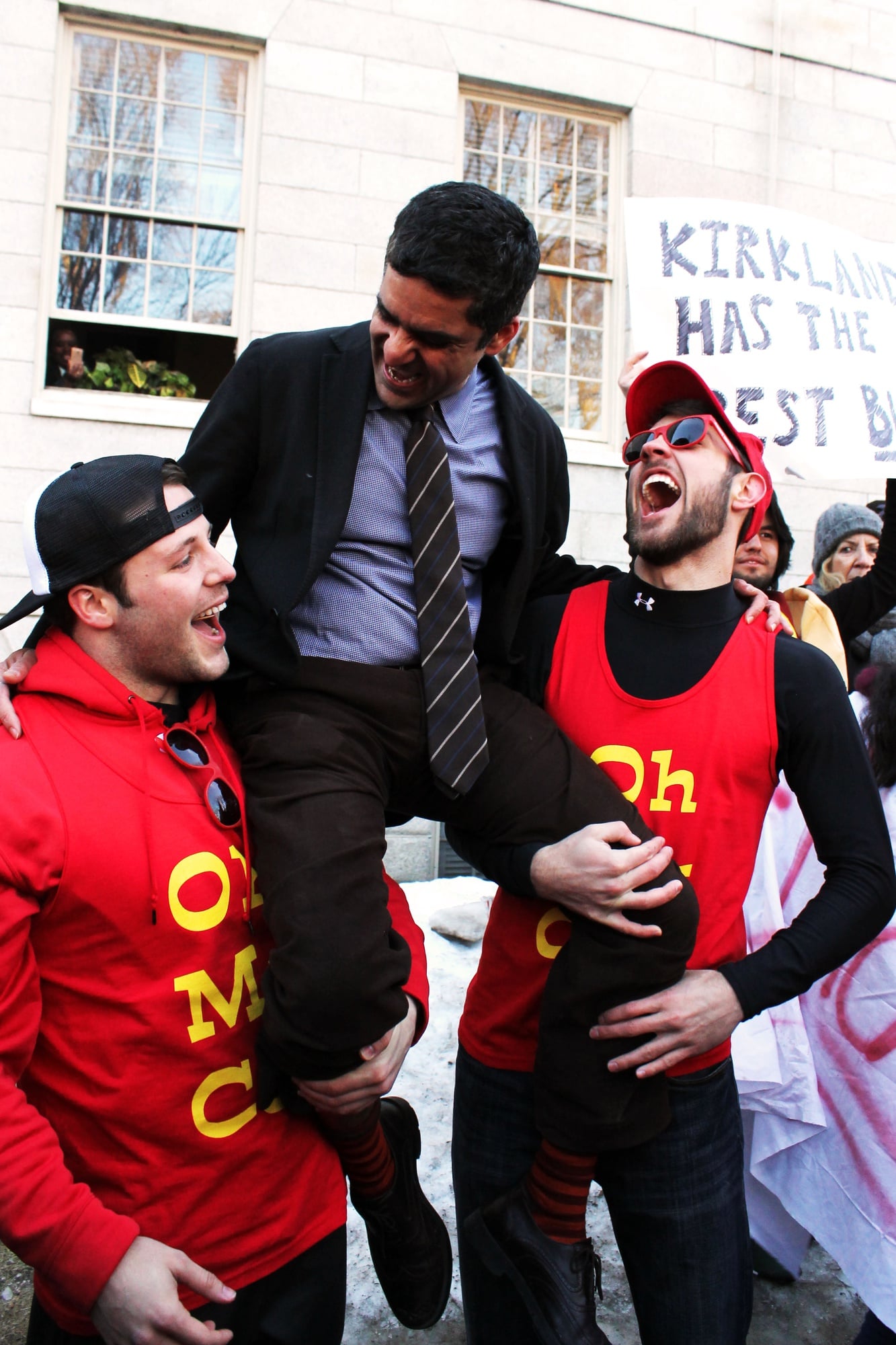 Dean of the College Rakesh Khurana, who also serves as co-master of Cabot House, sits on the shoulders of two Cabot House students. Upperclassmen stormed Harvard Yard on Thursday morning to start off Housing Day festivities.