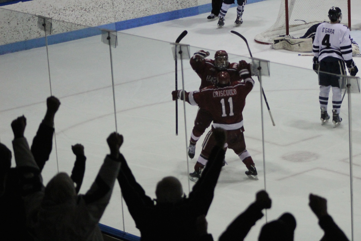 Vesey celebrates with junior co-captain Kyle Criscuolo. Harvard will play in the ECAC tournament's final weekend for the first time since 2012.