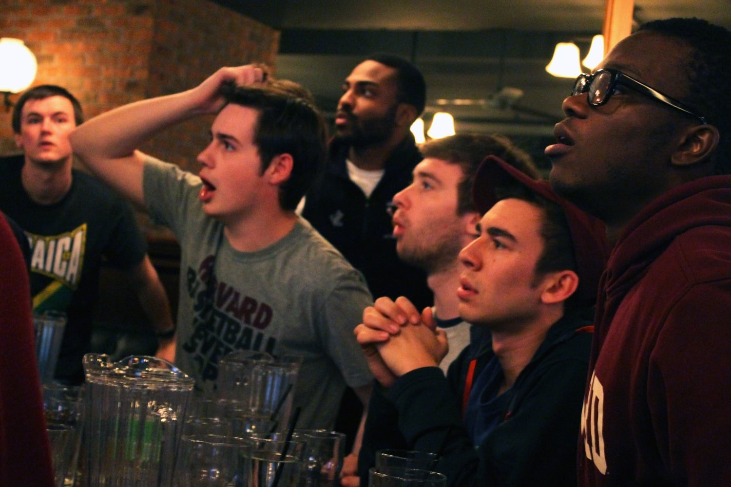 Harvard basketball fans watch the final moments of the Harvard vs. UNC game on Thursday at John Harvard's.