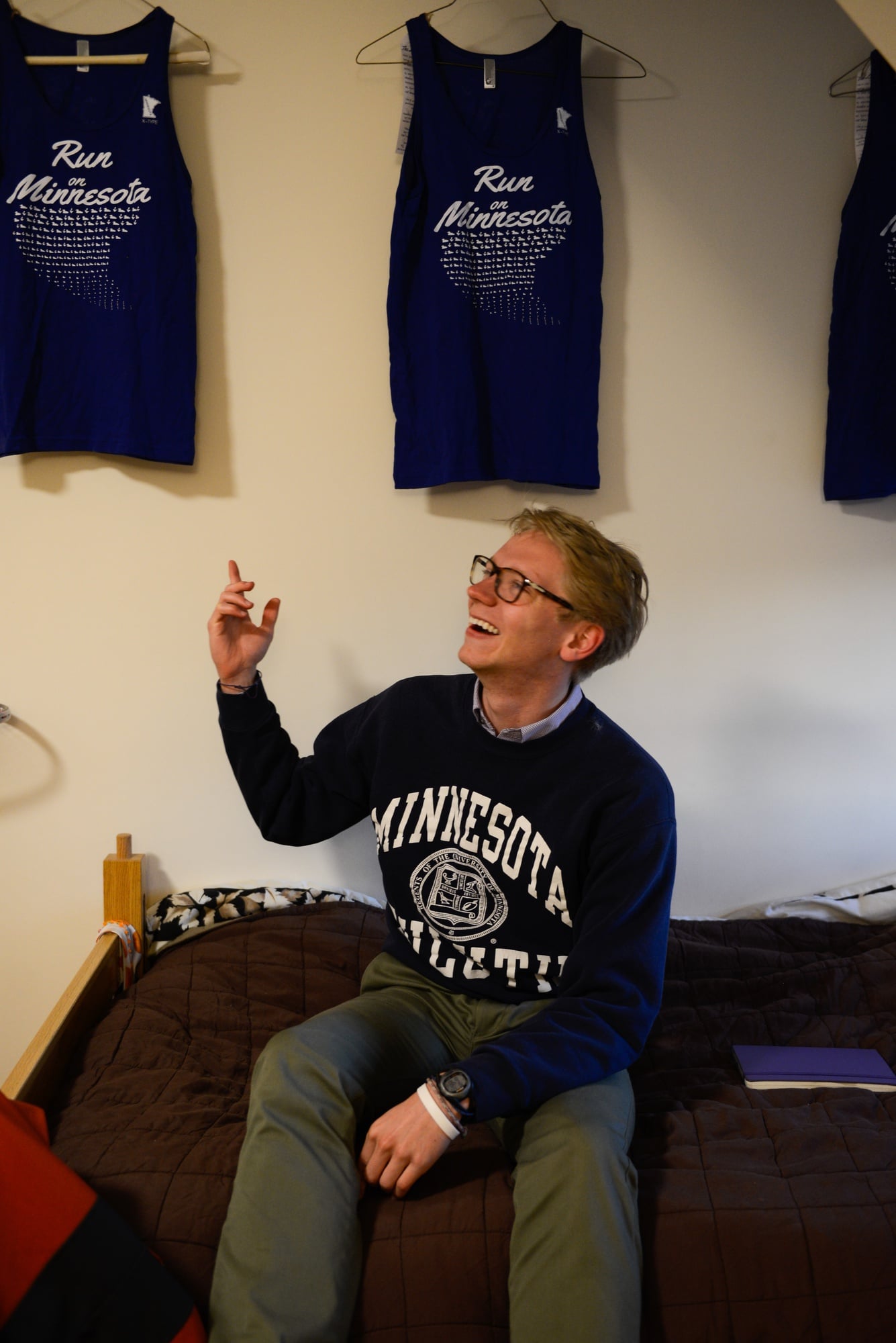 Luke R. Heine '17 shows off Minnesota running tank tops that he designed.