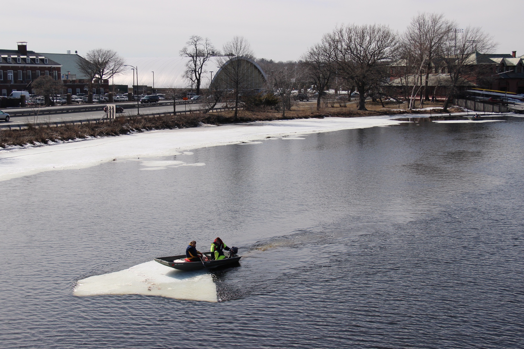 Coaches William Boyce and Hugo Gulliver clear residual ice from the Charles river Wednesday afternoon. The ice has limited dock access and rowing area in recent weeks, according to Lightweight Head Coach Michiel Bartman.