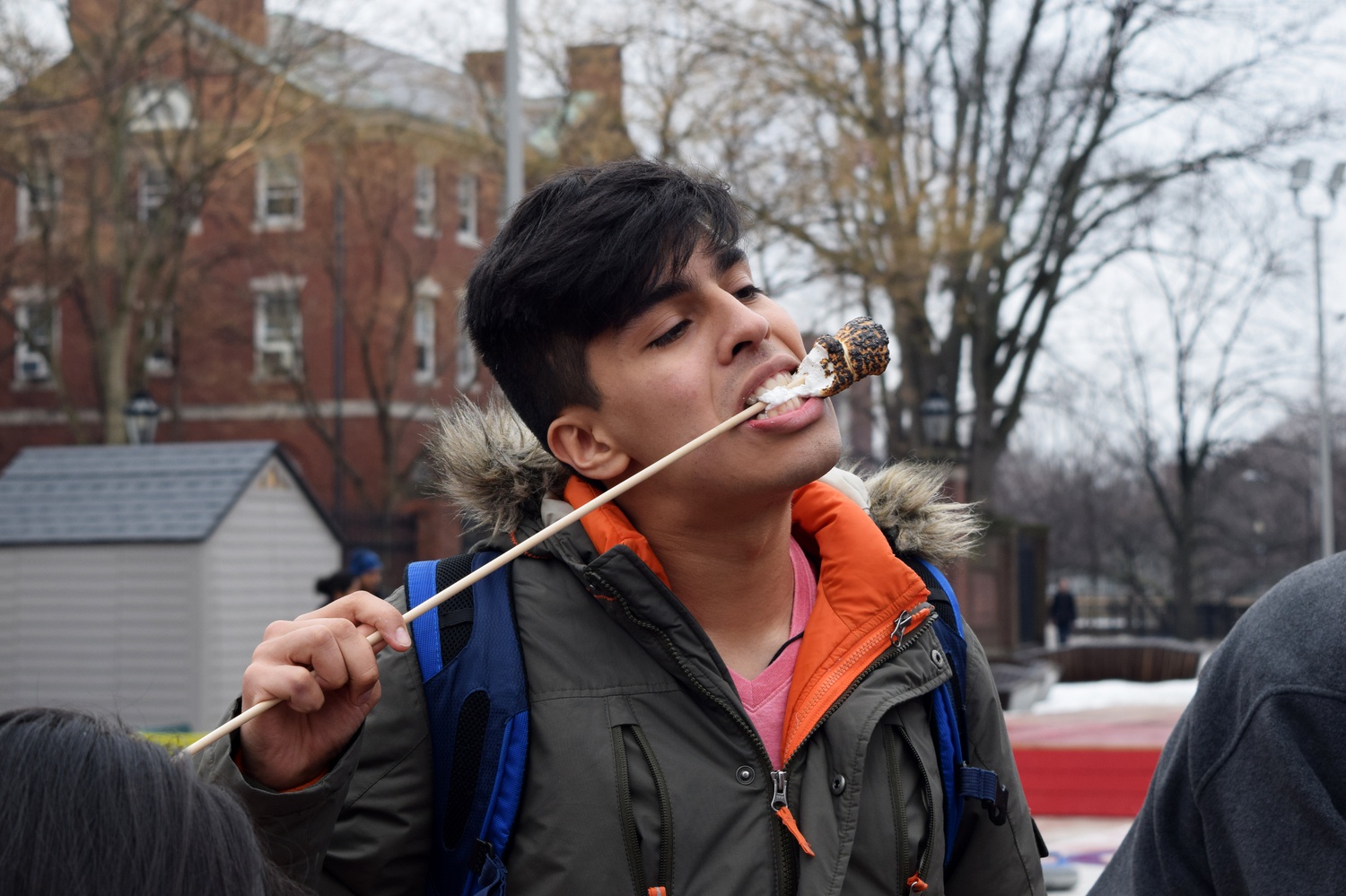 Nicolas A. Chavez '16 eats roasted marshmallows as part of President Drew G. Faust's event to welcome spring on Wednesday afternoon. While Chavez enjoyed the s'mores and hot chocolate he believed the event was a "sad attempt to be in touch with the community."