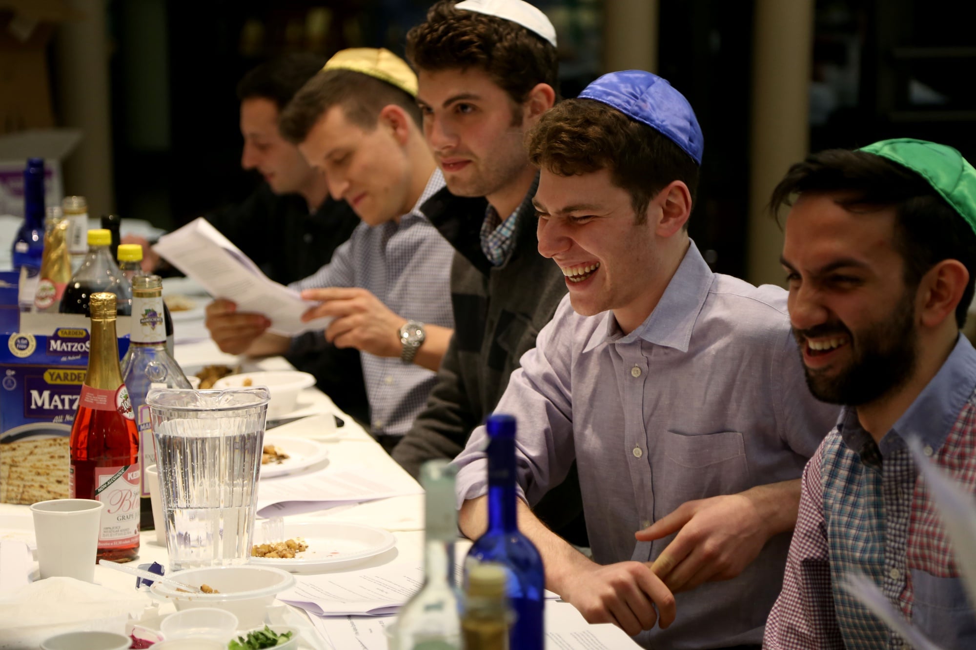 From right, Alpha Epsilon Pi brothers Aaron E. Pelz ’16, Crimson editor Gregory A. Briker ’17, Ethan S. H. Fried ’16, and Jacob S. Goldberg ’16 celebrate Passover during a seder, a traditional Jewish ritual, in Hillel on Saturday evening. 