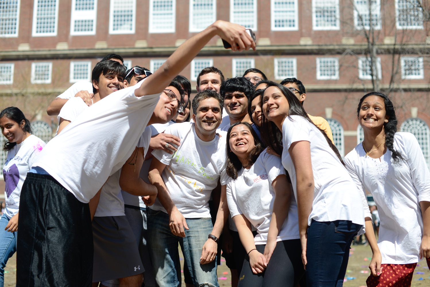 Dean of College Rakesh Khurana takes a selfie with a group of students at an event celebrating Holi on Sunday.