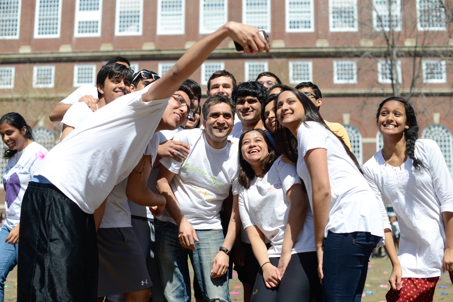 Dean of the College Rakesh Khurana takes a selfie with a group of students at an event celebrating Holi in 2015.
