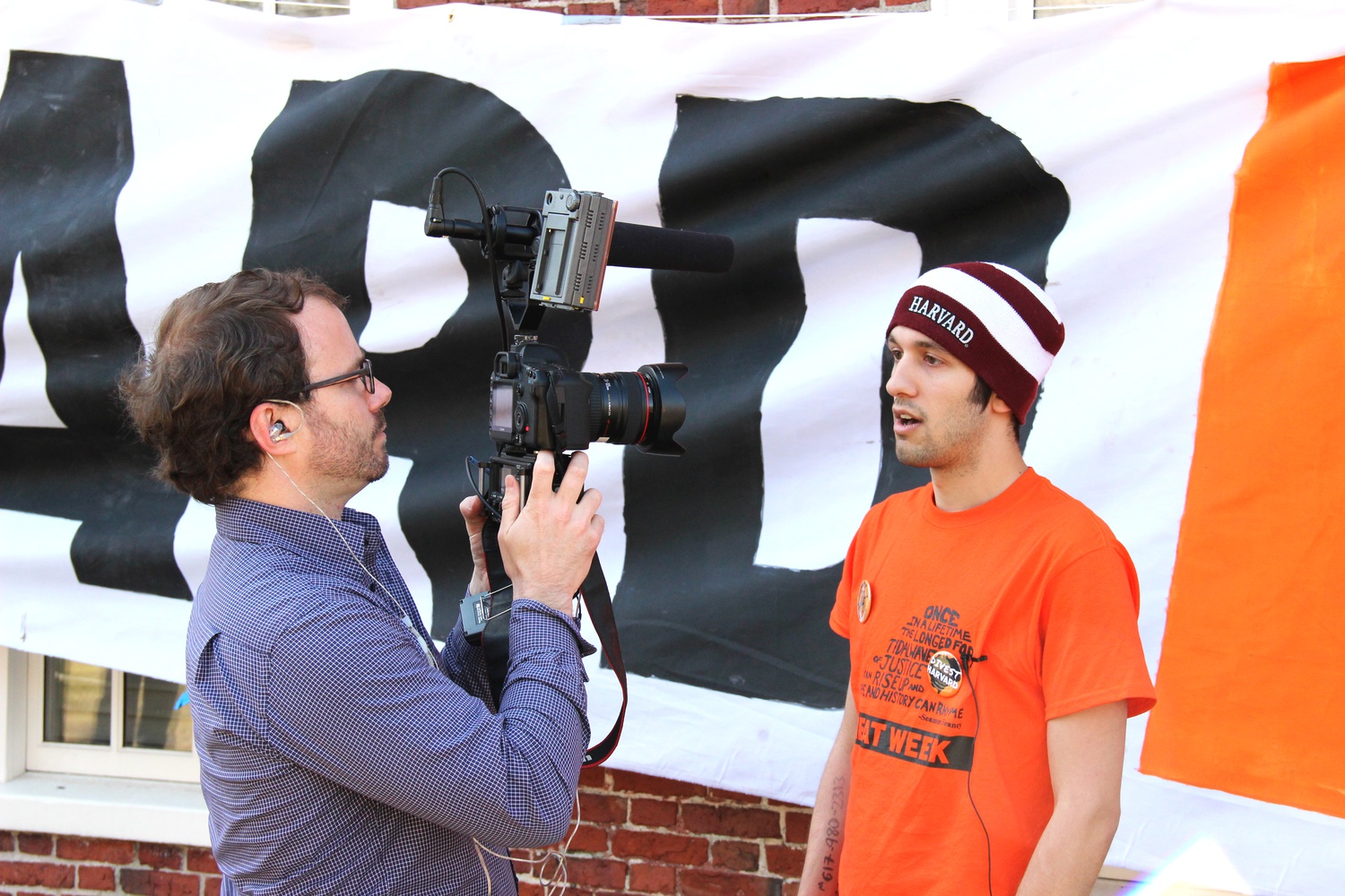  Morgan Robinson, a filmmaker hired by 350.org, interviews Rory Stewart, a Harvard School of Public Health student, during a blockade of Massachusetts Hall. Protesters held a kickoff rally Monday morning as part of "Harvard Heat Week."