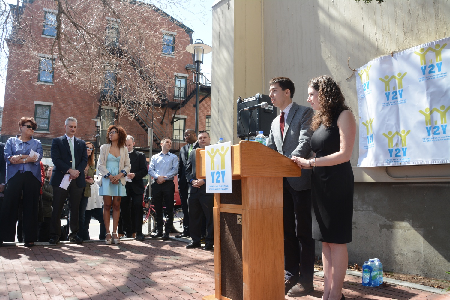 Samuel G. Greenberg ’14 and Sarah A. Rosenkrantz ’14, speak at the Y2Y youth homeless shelter launch event outside First Parish in Cambridge Monday. The shelter is set to open this November.