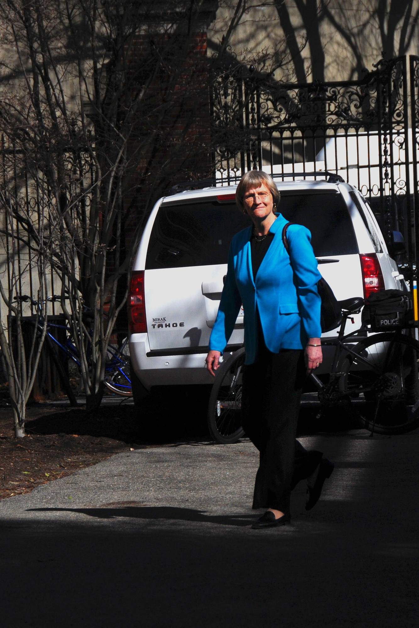 University President Drew G. Faust enters Emerson Hall, where members of the student activist group Divest Harvard attempted to confront her before she introduced a lecture on Wednesday afternoon. Security personnel had  placed guard rails between Loeb House and the lecture hall.