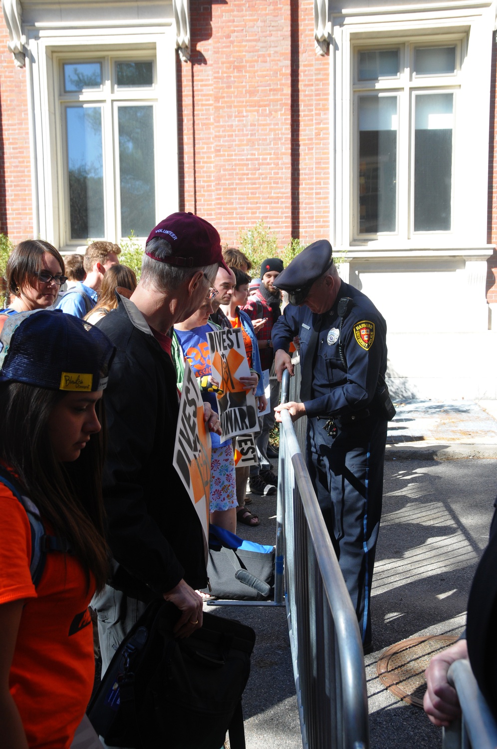 Harvard University Police reinforce a metal fence outside of Emerson Hall to ensure that University President Drew G. Faust could enter while Divest Harvard protesters attempted to confront her on Wednesday afternoon. The protesters have blockaded Massachusetts Hall since Sunday demanding the University divest from fossil fuels.