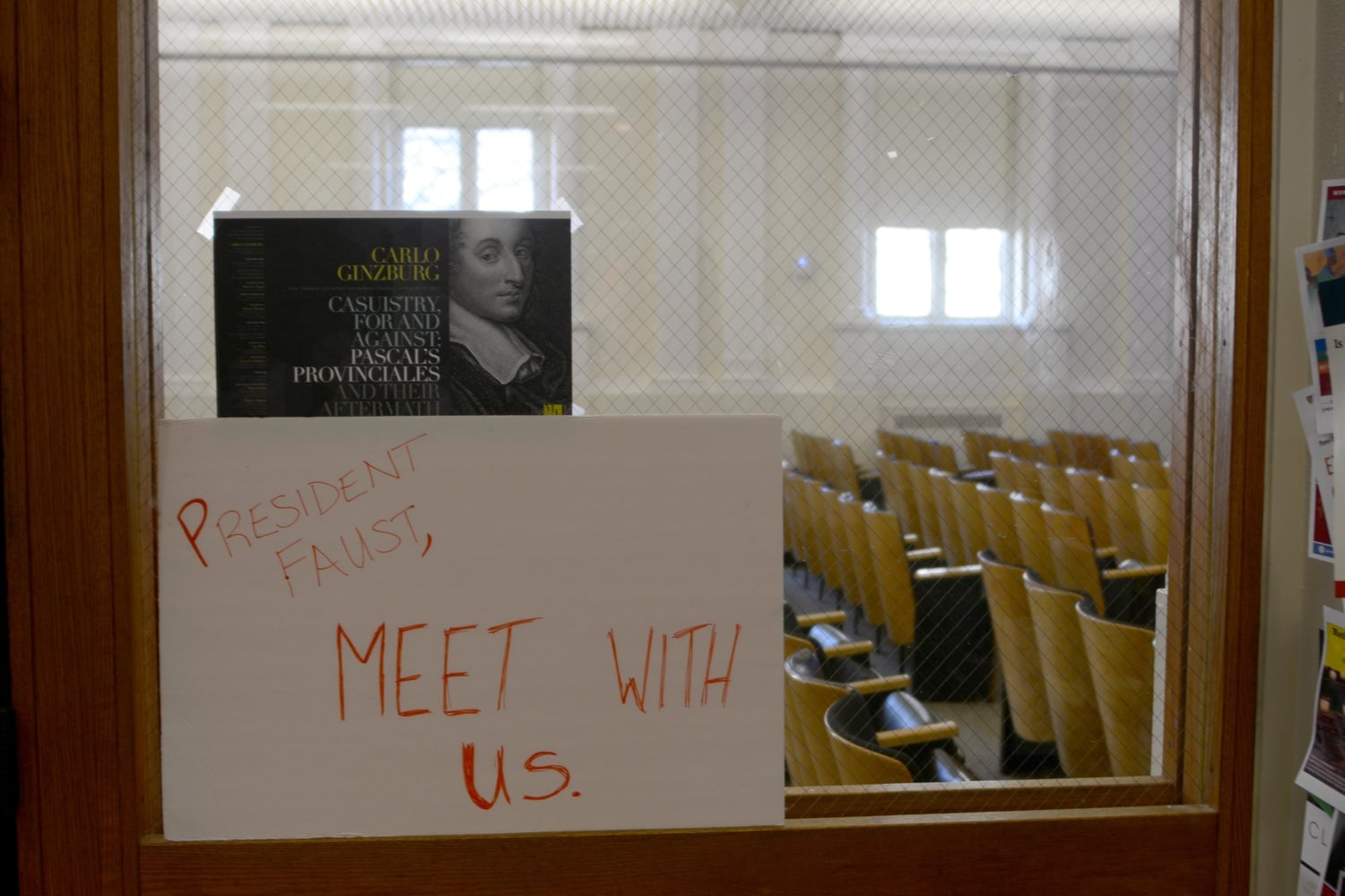 Divest Harvard protesters posted a sign at the entrance to an Emerson lecture hall where University President Drew G. Faust introduced a lecture event. 