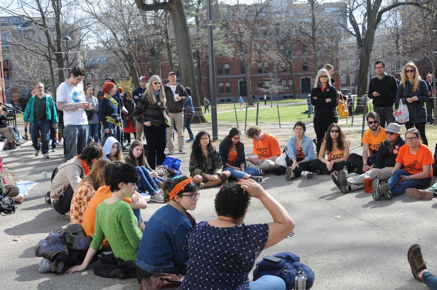 Students activists from different schools gather near the John Harvard statue during an open forum. The event took place Wednesday afternoon as part of Divest Harvard's "Harvard Heat Week."