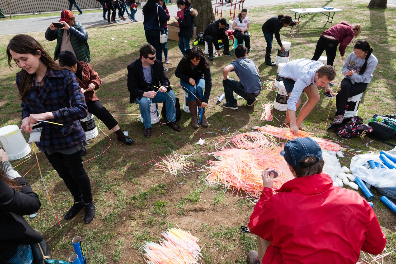 Attendees of the Harvard One Campaign connect glowsticks outside Memorial Hall as they attempt to create the longest chain of glowsticks on World Malaria Day.
