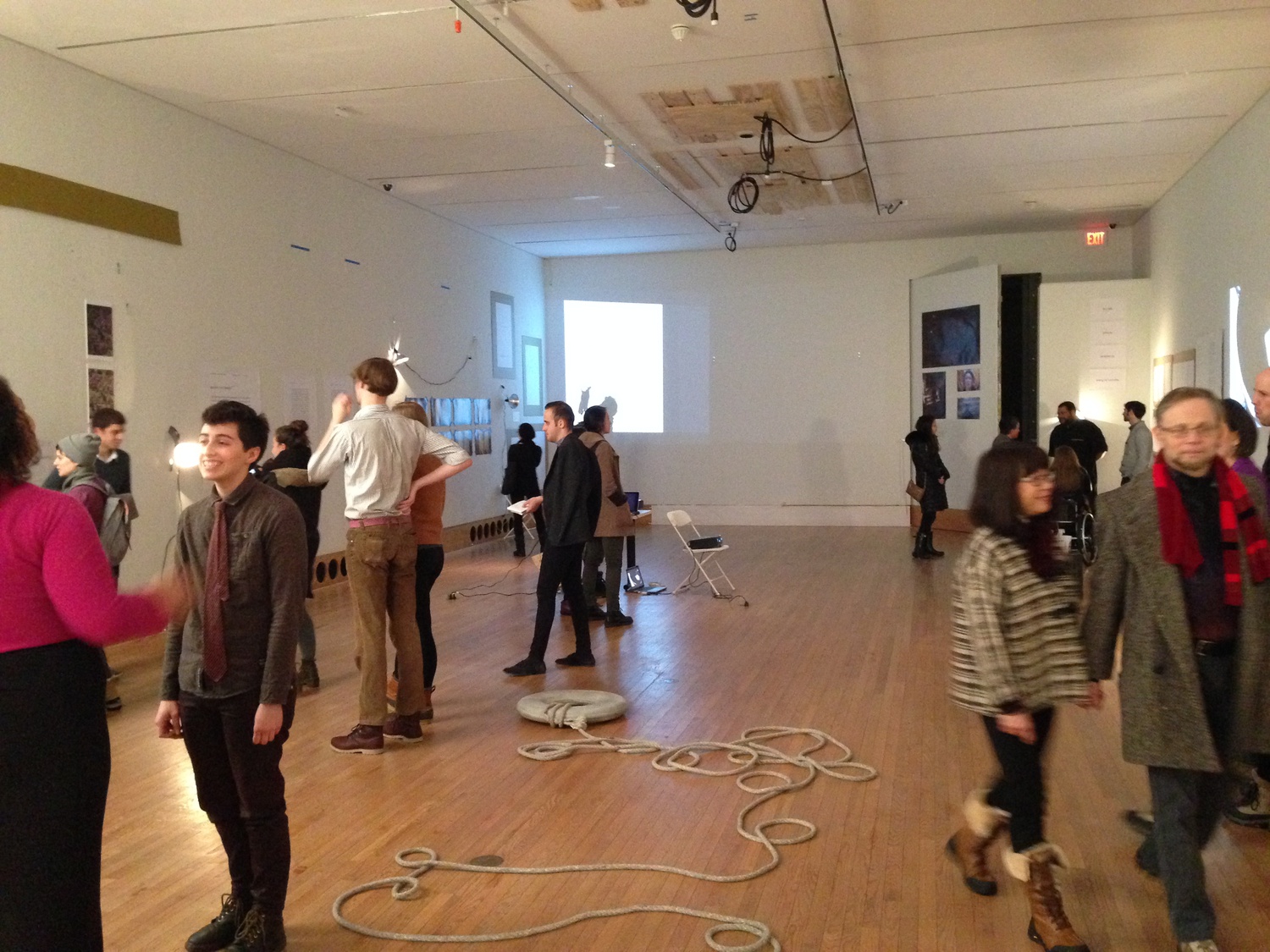 Visitors to the Arthur M. Sackler Museum view works from the exhibition opening of "here, without" on January 24.