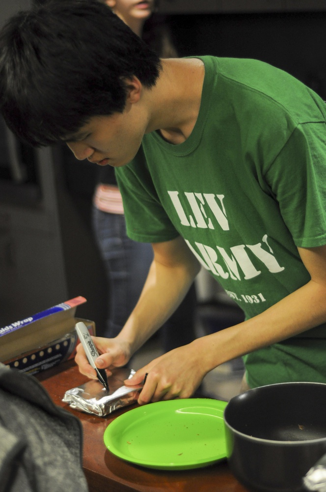 Henry Li ‘16 prepares a toasted sandwich for delivery on Monday night; students who texted members of the Harvard Ichthus, the student journal of Christian thought and expression with questions about Christianity received toasted sandwiches. 
