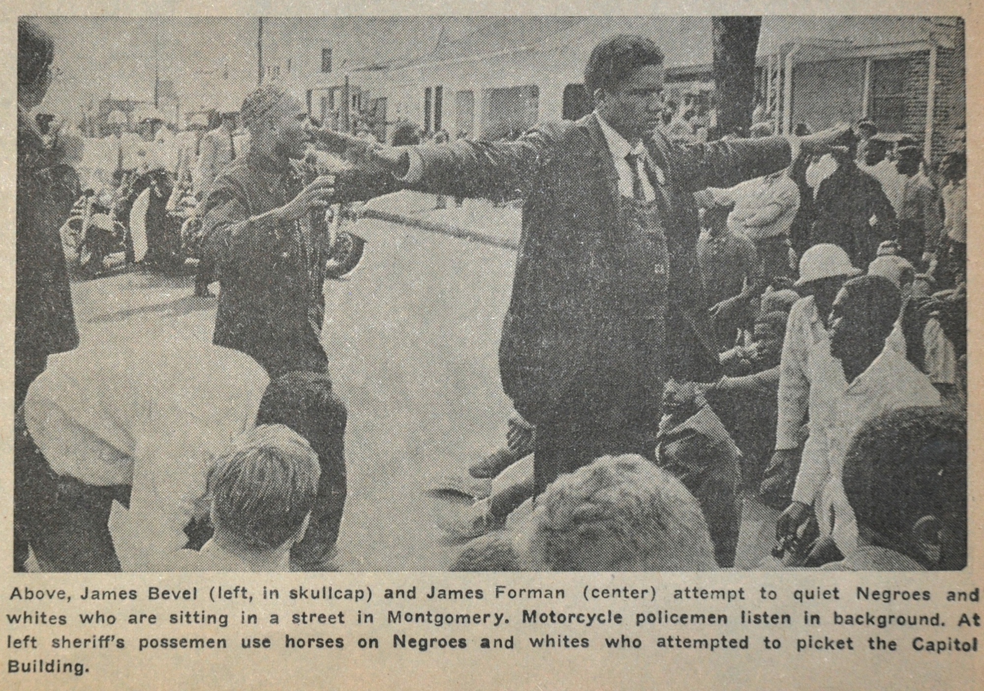 Above, James Bevel (left, in skullcap) and James Forman (center) attempted to calm people sitting in a street in Montgomery, AL. Motorcycle policemen listen in background. At left, sheriff’s possemen use horses to interfere in a picket of the Capitol building.