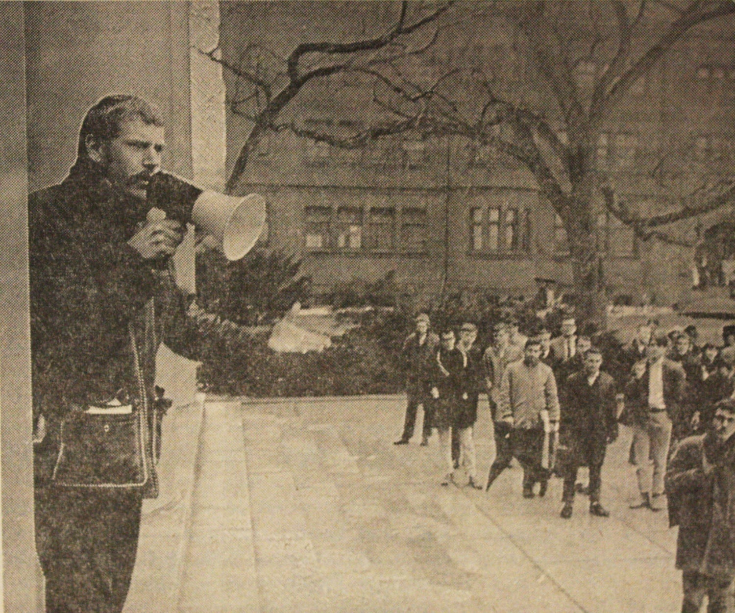 A photograph of Albert Maher '63-2 entreating a mob at Memorial Church appeared in The Crimson on February 13, 1965.