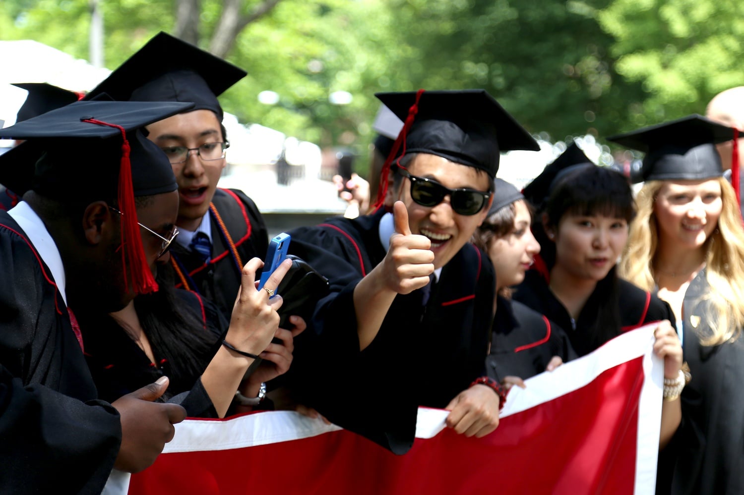 Senior class marshal Bob Wu '15 gives a thumbs up as the 2015 class marshals pose for photographs in the Yard before the Baccalaureate Service on May 26.