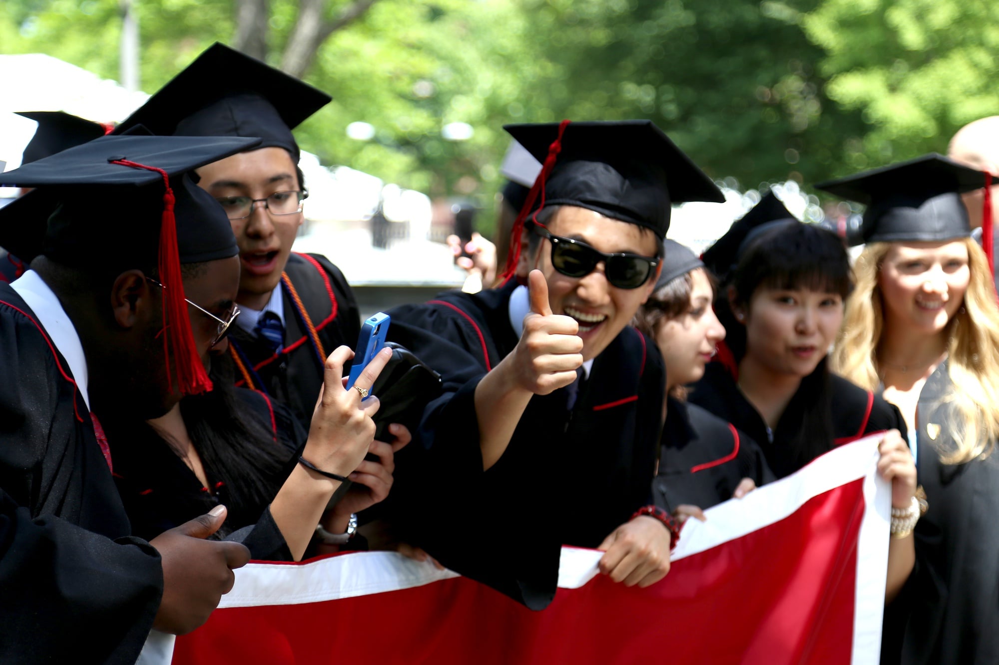 Senior class marshal Bob Wu '15 gives a thumbs up as the 2015 class marshals pose for photographs in the Yard before the Baccalaureate Service on May 26.