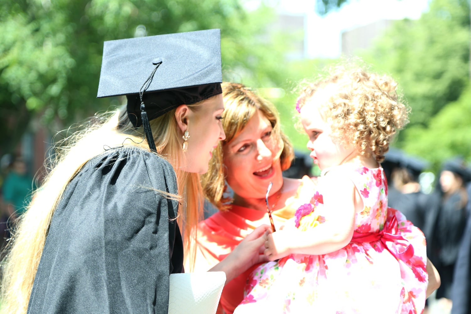 Lizzy R. Fitzhenry ’15 embraces her mother, Joan, and her 21-month-old niece before entering Memorial Church for the 2015 Baccalaureate Service. Joan Fitzhenry described the experience of Commencement so far as "wonderful, teary." 