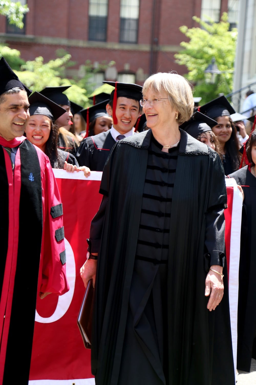 University President Drew G. Faust leads the Class of 2015 in a procession toward Memorial Church for the 2015 Baccalaureate Service on May 26. Dean of the College Rakesh Khurana smiles at left and the 2015 class marshals follow behind.