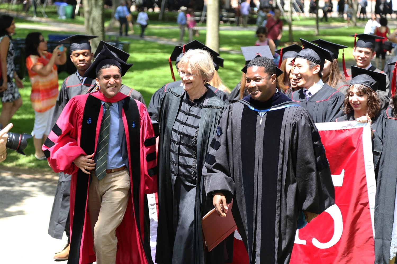 Dean of the College Rakesh Khurana, left, University President Drew G. Faust, center, and Reverend Jonathan L. Walton, right, lead the Class of 2015 to Memorial Church for the 2015 Baccalaureate Service on May 26.