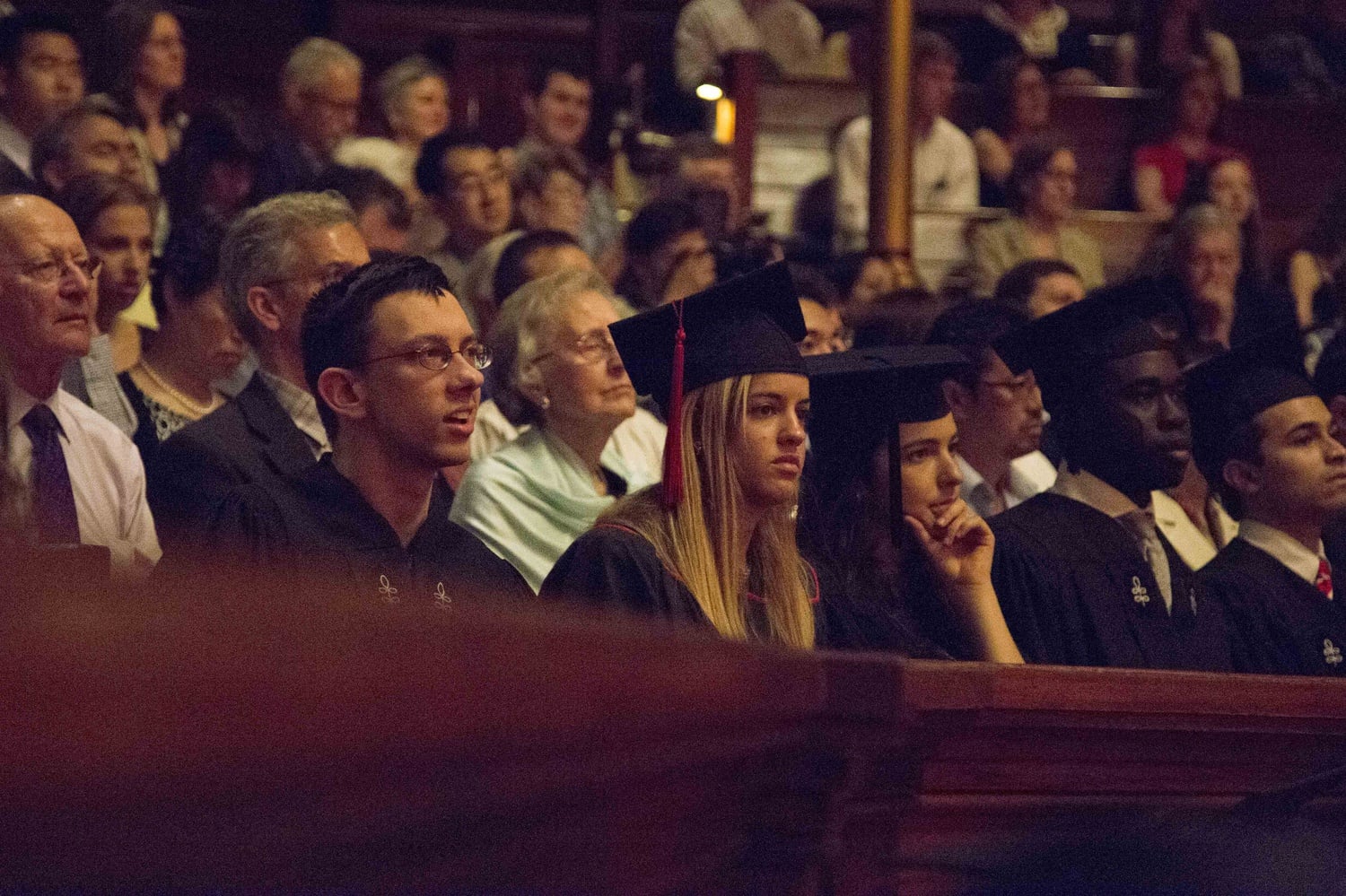 Evan M. O'Dorney '15 listens as the Harvard-Radcliffe Collegium Musicum performs a hymn by Oliver Wendell Holmes that O'Dorney set to music during the 2015 Phi Beta Kappa Literary Exercises on May 26 in Sanders Theatre. 
