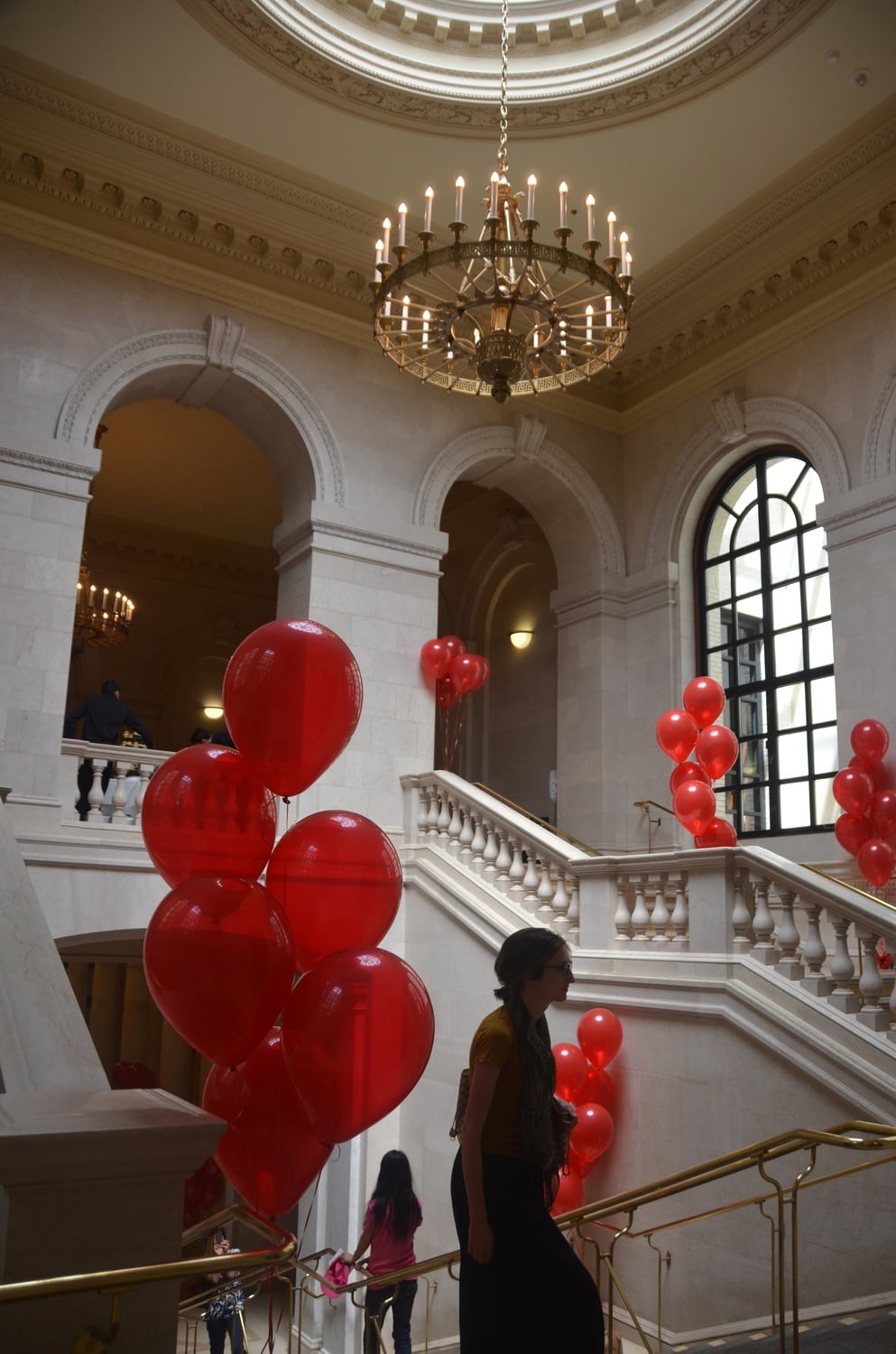 Visitors walk among red balloons at Widener Library on Friday. Administrators commemorated the 100th anniversary of the library's founding with a celebration.