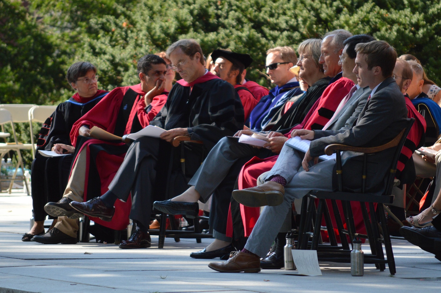 Various administrators, including Dean of the College Rakesh Khurana, Dean of Freshman Thomas A. Dingman ‘67, and University President Drew G. Faust, sit on the stage in Tercentenary Theatre during Freshman Convocation.