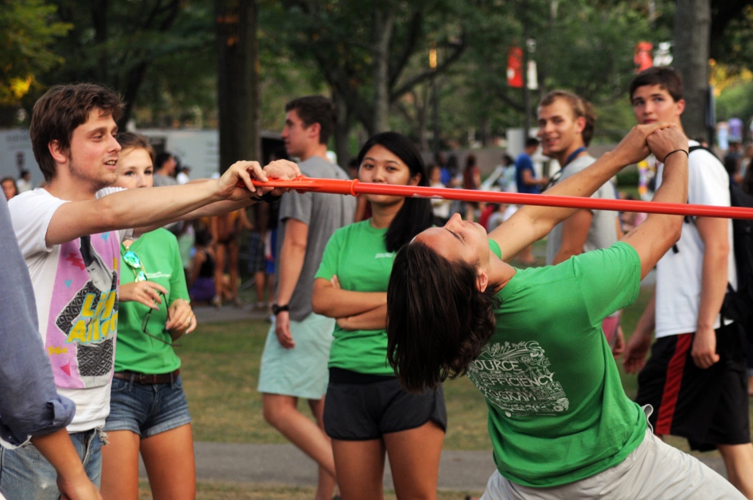 Harvard students compete in limbo at Camp Harvard on Monday evening in Tercentenary Theatre.