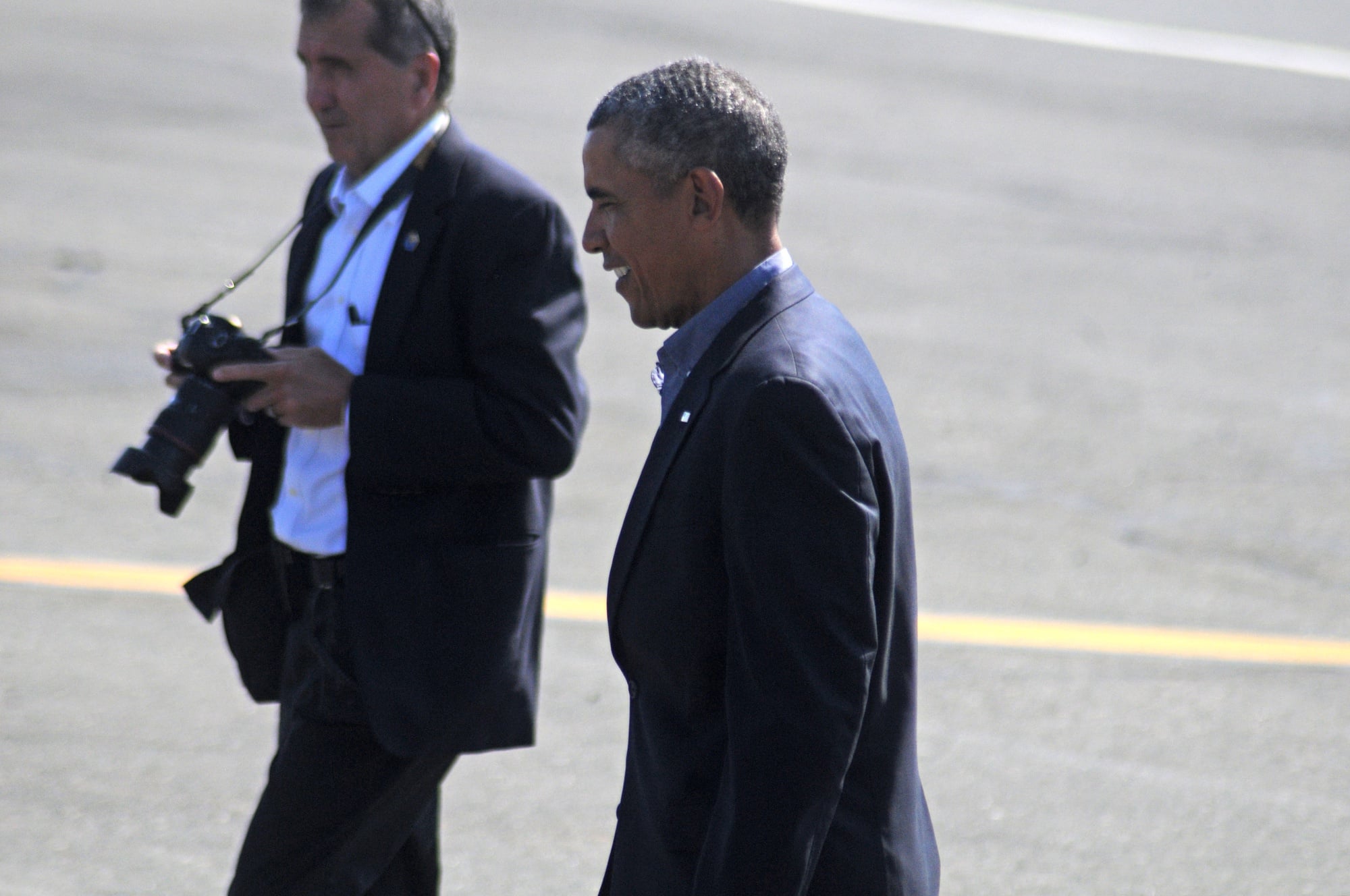 President Barack Obama walks across the tarmac after arriving in Boston on Monday.