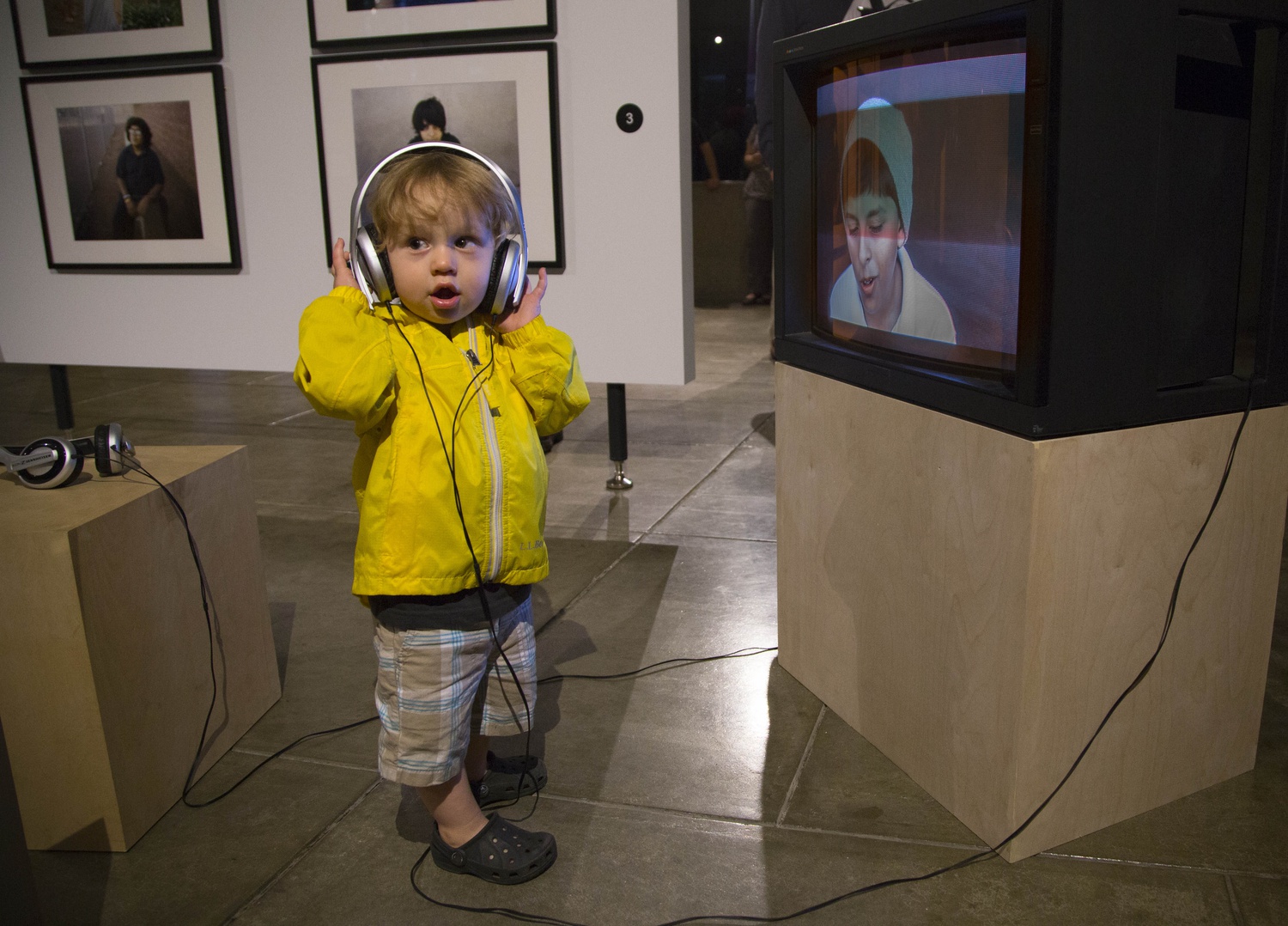 20 month-old Otomars P. Macrizo listens to a video piece about teenage Americans born at the end of the twentieth century by Visual and Environmental Studies Visiting Associate Professor Betsy Schneider. The work is on display at the Carpenter Center as part of an exhibition for visiting faculty artists.
