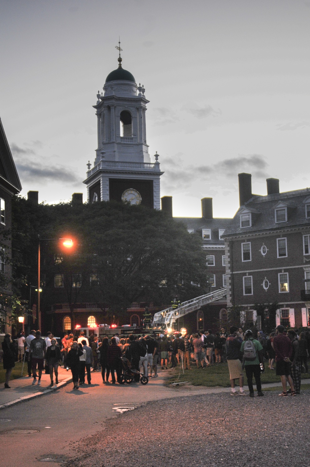 Students from Eliot and Kirkland Houses watch as the Cambridge Fire Department responds to a fire Monday evening.