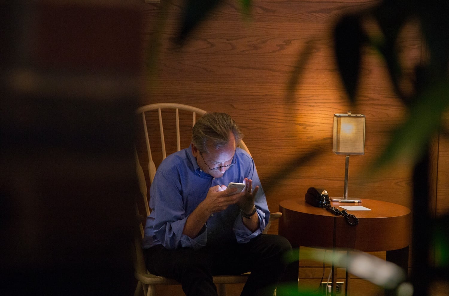 Harvard Law School professor Larry Lessig works on his cell phone in the lobby of the Charles Hotel. Lessig, who announced his presidential bid in early September, had been traveling extensively and was anxious about booking a last-minute flight to Washington, D.C.